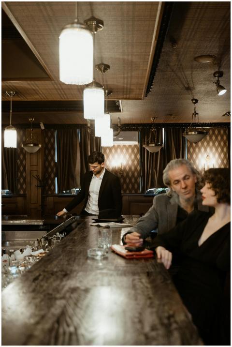 Sophisticated bar scene with people interacting at
