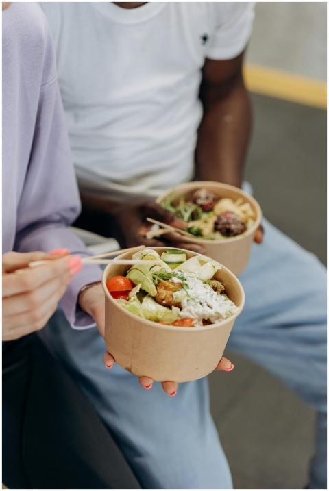 Two people enjoying nutritious salad bowls with fr