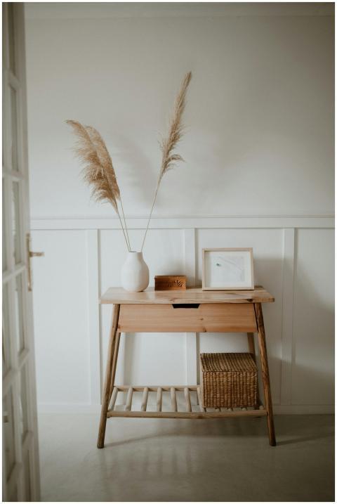 A serene minimalist interior features a wooden con