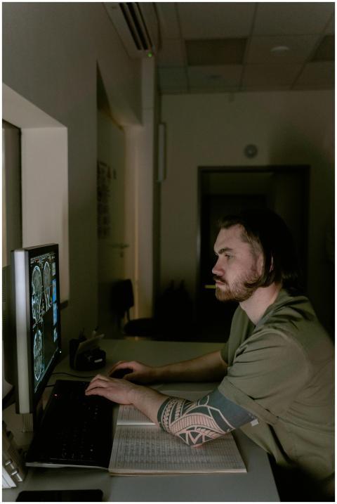 Radiologist examining brain CT scans on a computer