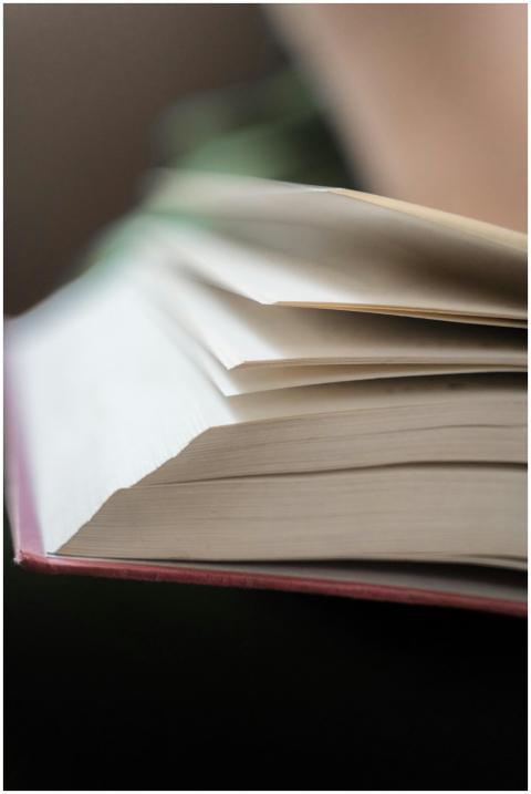 A close-up photograph of an open book, showing the