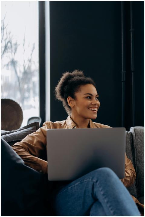 African American woman smiling while working on la