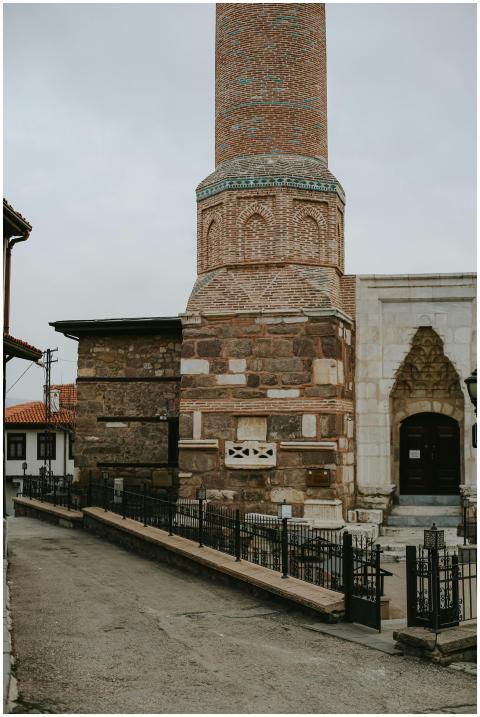 A historic mosque tower on a quiet village street
