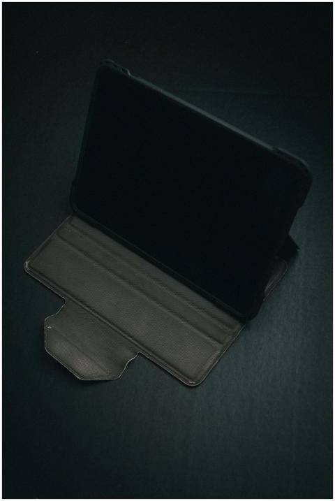 A black tablet in an open protective case, viewed