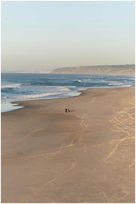 Serene aerial view of a couple walking on the expa