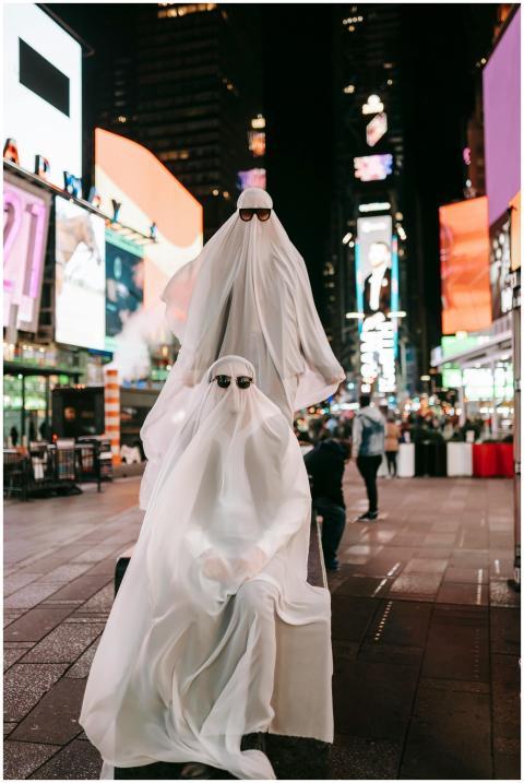Full body of anonymous couple wearing ghost costum