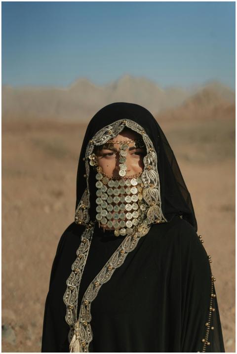 Woman wearing traditional Bedouin attire with coin