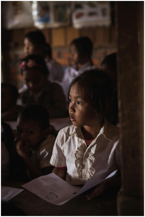 Focused children in a dimly lit classroom attentiv