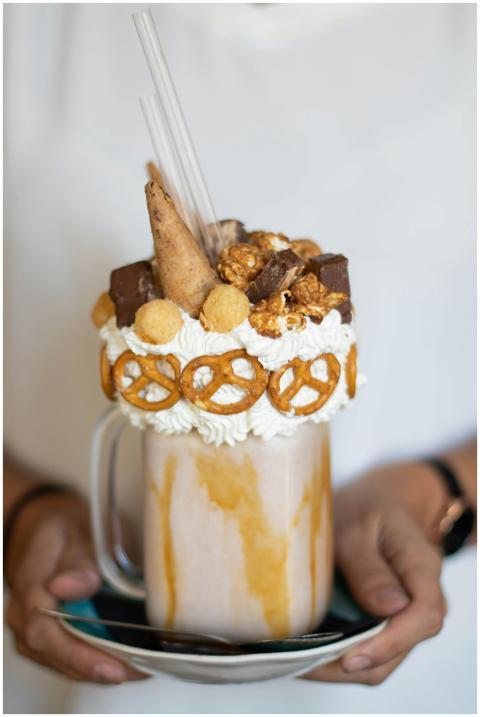 A delectable dessert milkshake adorned with pretze