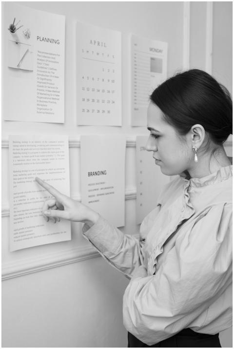 Focused young woman analyzes planning documents on