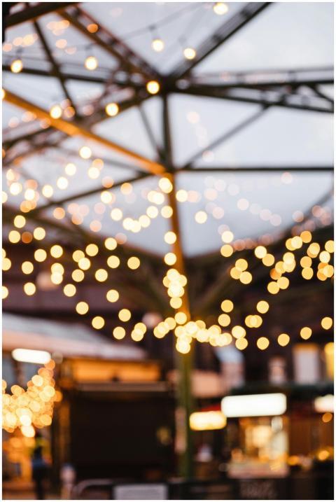 Many shimmering round lights of garland under ceil