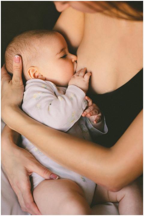 A close-up of a mother lovingly breastfeeding her