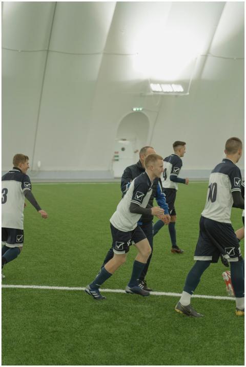 Young soccer team practicing indoors on artificial