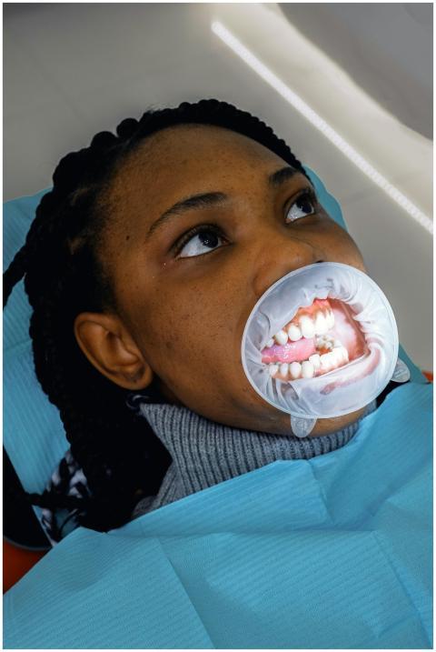 Young woman undergoing dental examination with a m