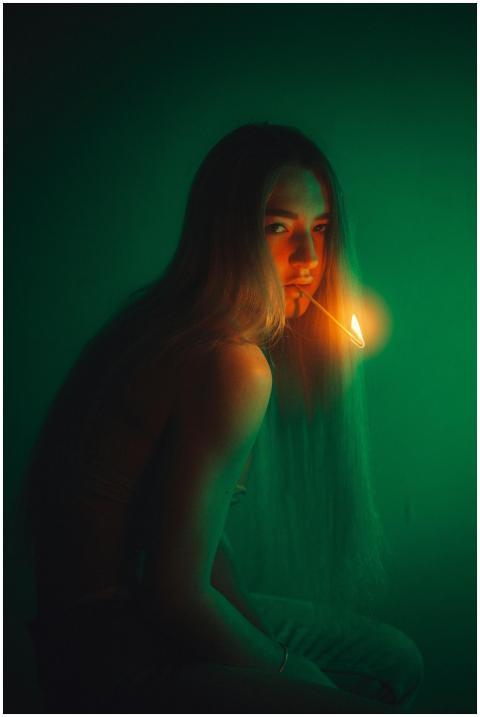 An artistic portrait of a woman with a matchstick