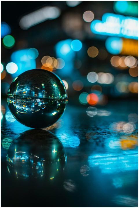 A mesmerizing glass sphere reflects vibrant city l