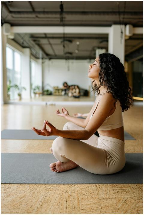 A young woman in a yoga pose practicing meditation