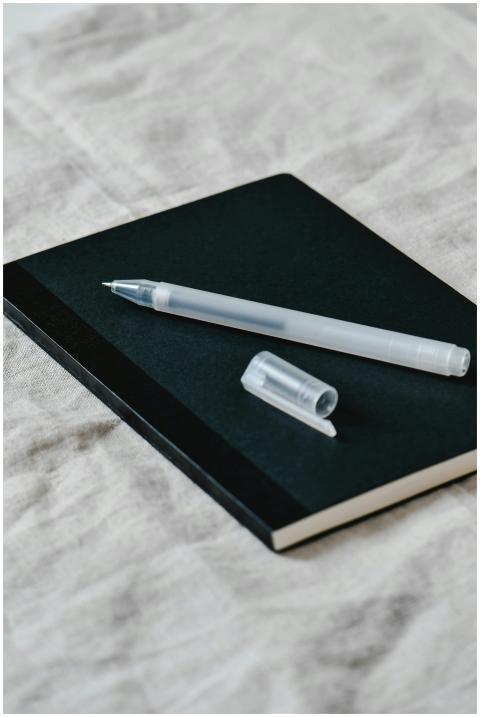 Close-up of a minimalist notebook with a pen on a