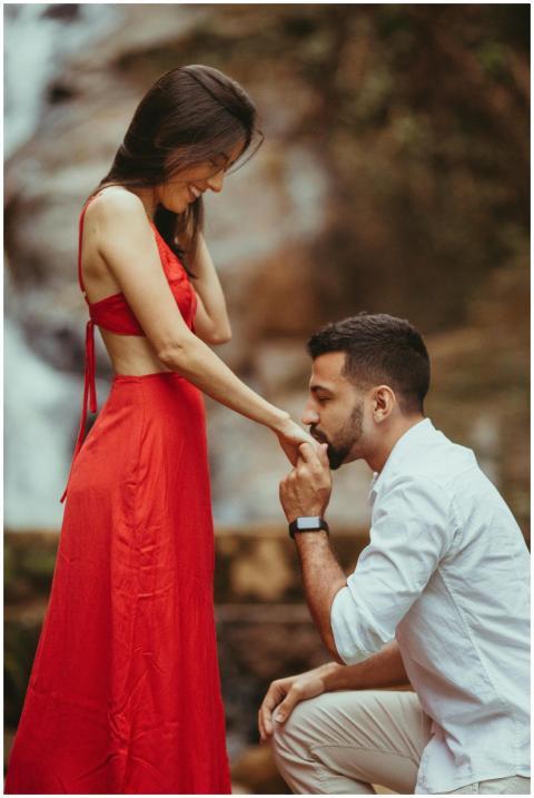 Couple sharing a romantic moment by a waterfall in