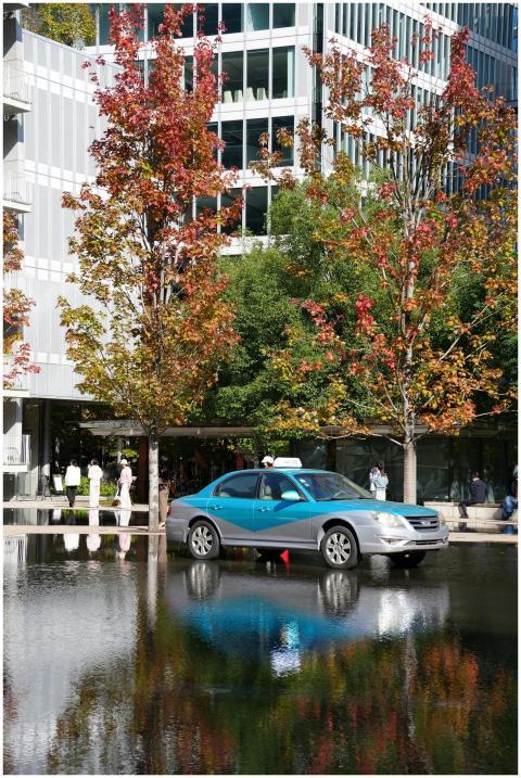 Vibrant autumn city scene featuring trees and a ca