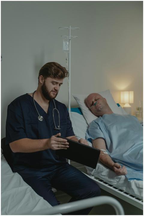 A doctor in a scrub suit caring for a patient in a
