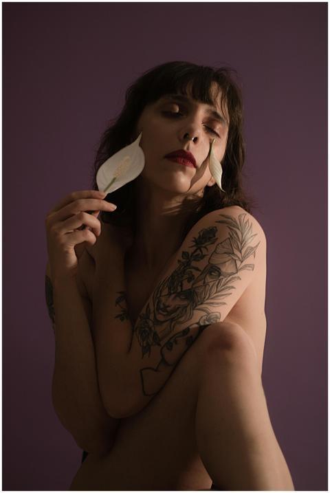 Artistic portrait of a woman with floral tattoos h