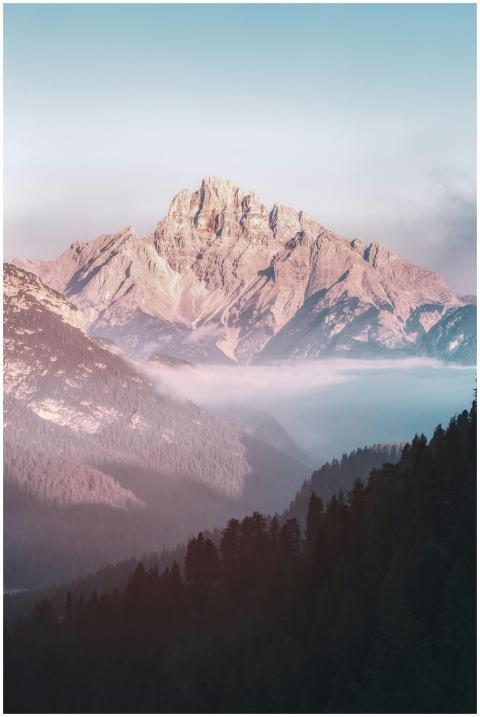 Breathtaking mountain scenery at sunrise with mist