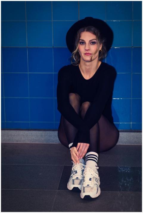 Fashionable young woman sitting casually in a mode