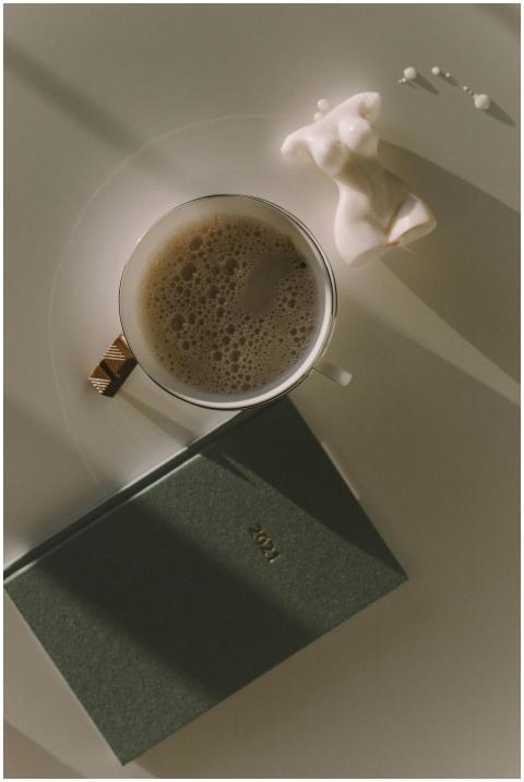 Elegant flat lay featuring a coffee cup, figurine,