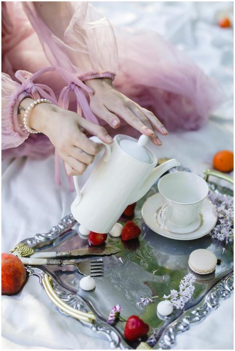 A charming tea setup outdoors with floral accents,