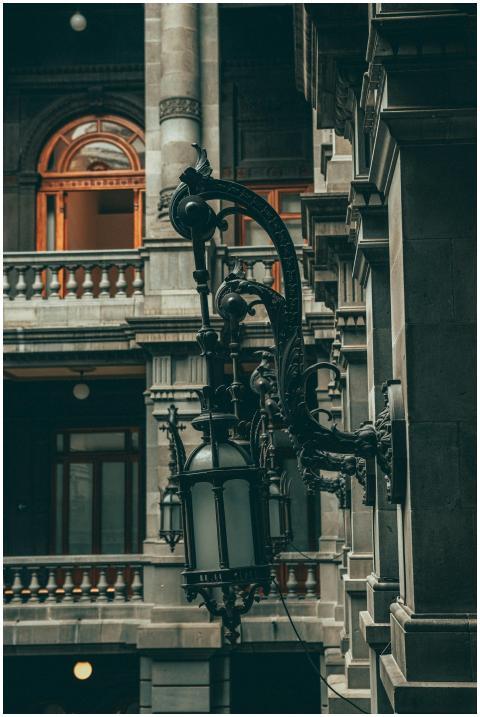 Ornate vintage lamps on historic architecture in M