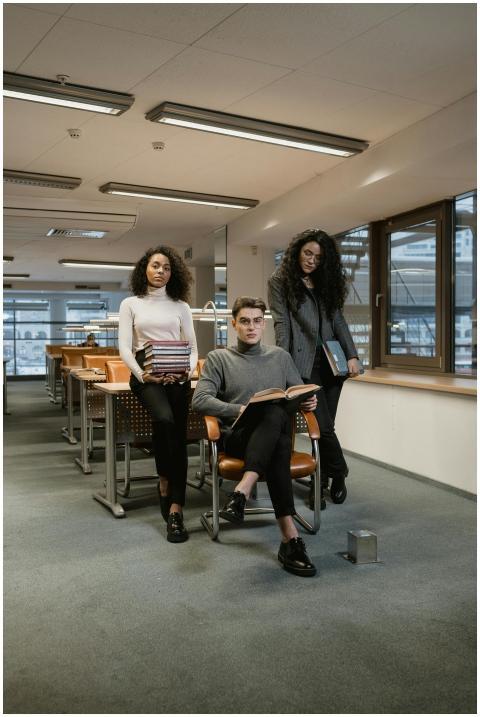 Three young college students studying together in