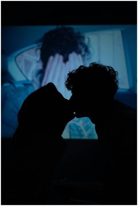 Silhouette of a couple kissing with a dramatic pro