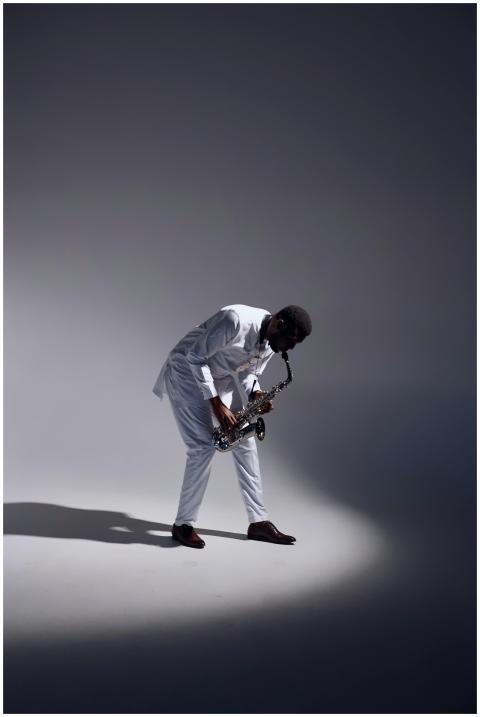 A well-dressed saxophonist performs passionately i