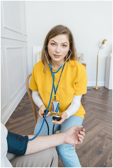 Medical professional checking patient's blood pres