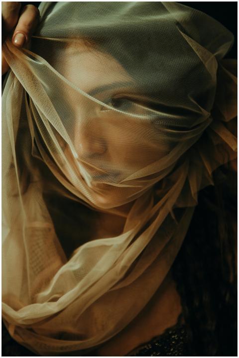 Artistic portrait of a woman shrouded in sheer fab