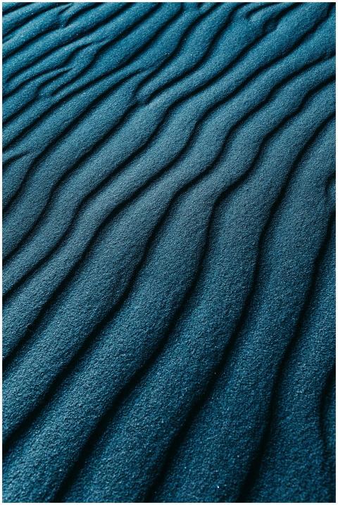 From above of bright texture of sand putting wavil