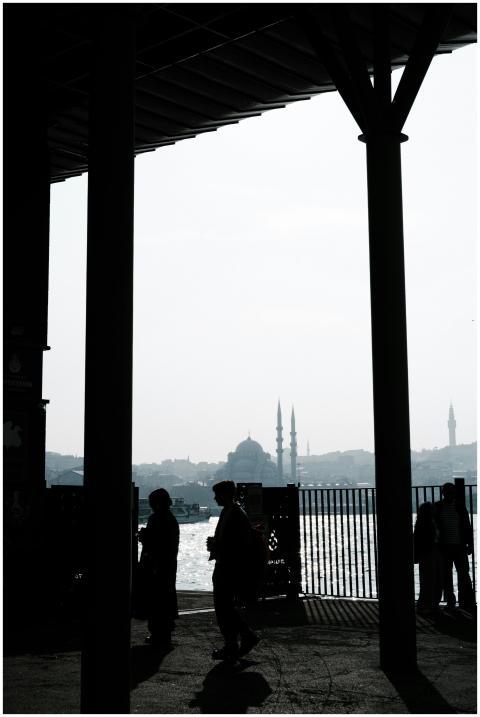 Silhouette of people against Istanbul skyline with