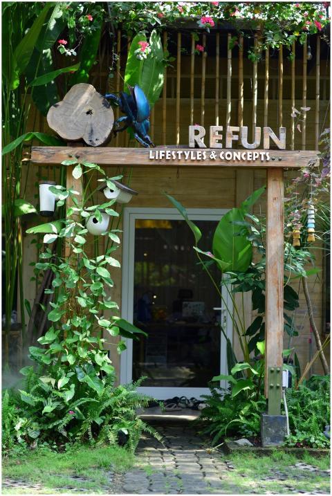 Lush greenery surrounds the entrance of an eco-fri