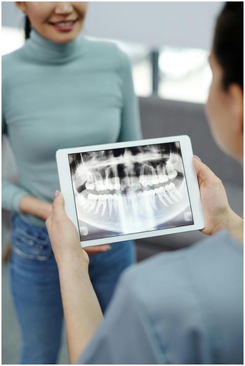 Close-up of dental x-ray on tablet held by profess