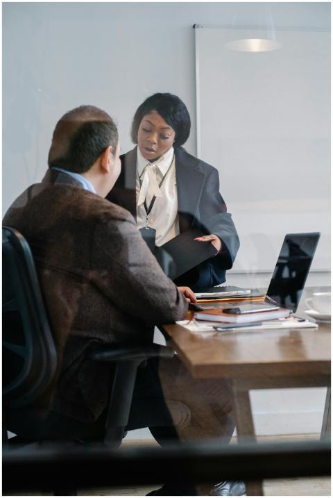 Two professionals engage in a strategic discussion