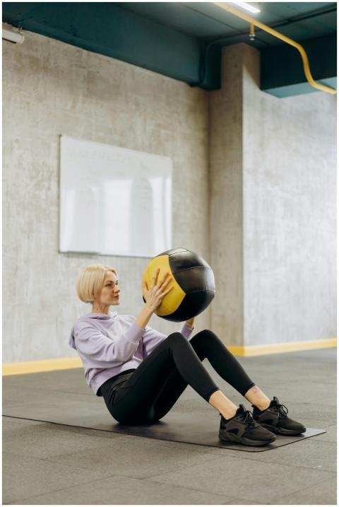 Fit woman balancing with a medicine ball during wo