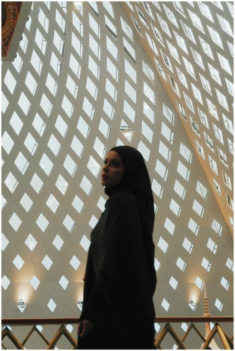 Silhouette of a woman inside a mosque showcasing i