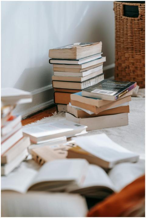 Collection of books placed on white soft textile o