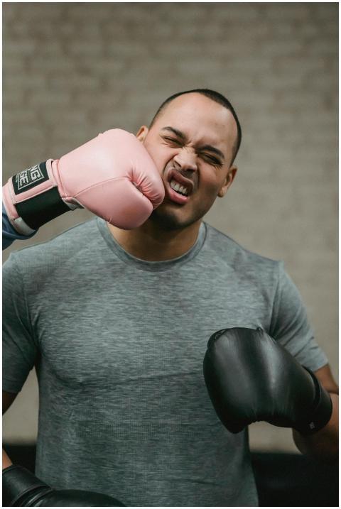 Muscular young ethnic male boxer in activewear rec