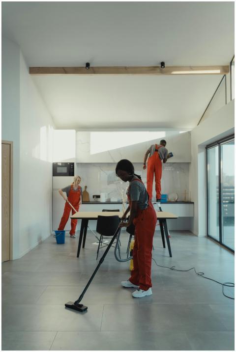 A diverse group of professionals cleaning a modern