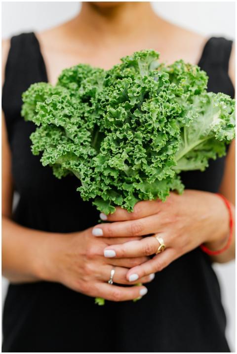 Close-up of woman holding fresh kale in her hands