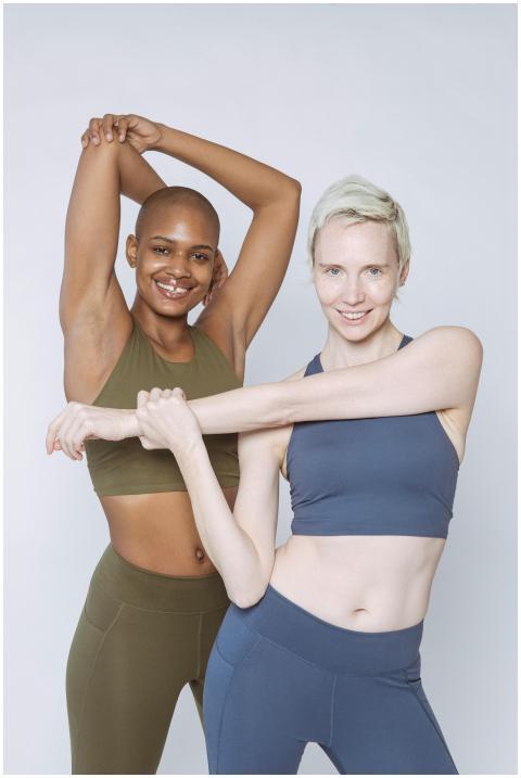 Diverse female models in sportswear smiling and lo