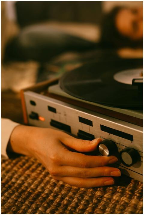 Close-up of hands adjusting a vintage vinyl record