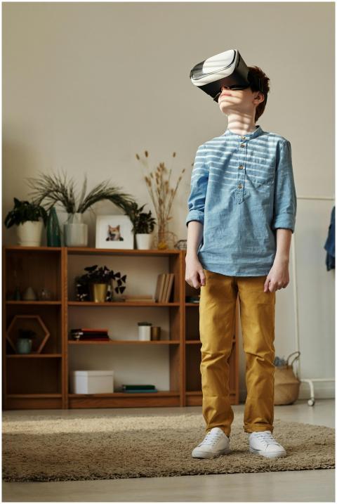 A young boy wearing VR goggles, exploring virtual